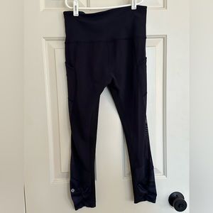Lululemon Size 6 Navy Leggings with mesh side paneling and solid Navy on back